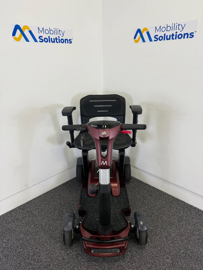Mobility scooter with 'Mobility Solutions' logo on a white wall background