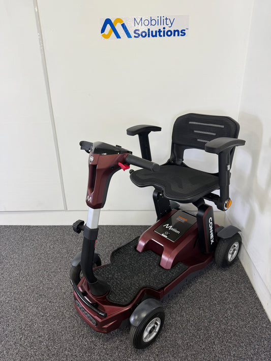 Mobility scooter with 'Mobility Solutions' logo on a gray floor.