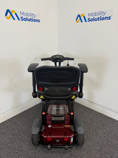 Mobility scooter with 'Mobility Solutions' branding on a white wall.