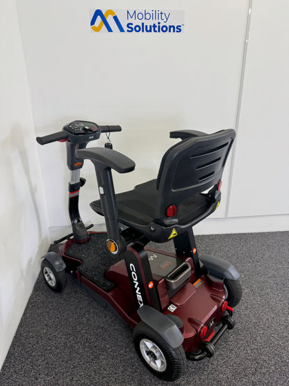Mobility scooter with 'Mobility Solutions' logo on a white wall background