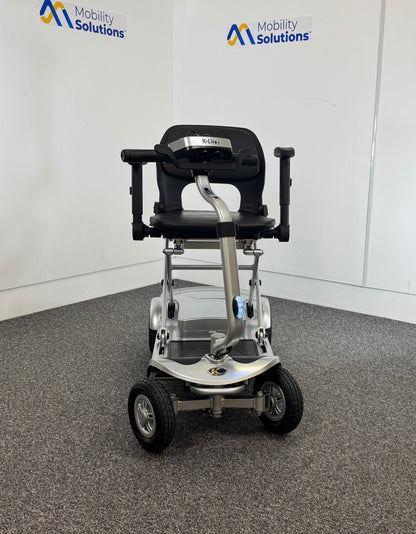 Mobility scooter with adjustable seat on a gray floor, branded 'Mobility Solutions'.